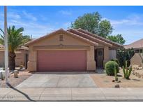 Single-story house with a two-car garage, desert landscaping, and concrete driveway at 2467 E Winchester Pl, Chandler, AZ 85286