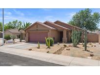 Single-story home with desert landscaping, covered porch, and two-car garage at 2467 E Winchester Pl, Chandler, AZ 85286