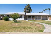 Charming single-story home with well-maintained lawn and inviting walkway, offering classic curb appeal at 2740 N 21St Dr, Phoenix, AZ 85009