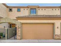 Charming home featuring a tan facade, two-car garage, and gated front entry at 3820 E Mcdowell Rd # 102, Phoenix, AZ 85008