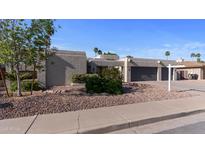 Stunning desert home featuring a spacious three-car garage and low-maintenance landscaping at 6126 E Paradise Ln, Scottsdale, AZ 85254
