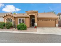 Charming single-story home featuring desert landscaping, a tile roof, and an attached two-car garage at 6713 E Riverdale St, Mesa, AZ 85215