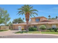 Charming home featuring desert landscaping, mature palm trees, and a two-car garage at 8443 E Via De Los Libros --, Scottsdale, AZ 85258