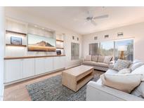Bright and airy living room featuring a built-in entertainment center and comfortable neutral furniture at 8880 E Paraiso Dr # 118, Scottsdale, AZ 85255