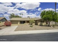 Charming single-story home featuring a two-car garage and low-maintenance desert landscaping at 124 E Fremont Dr, Tempe, AZ 85282