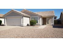 Single-level home with a front-facing two-car garage and low-maintenance desert landscaping at 2350 E Nunneley Ct, Gilbert, AZ 85296