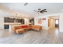 Open floor plan featuring tile floors, modern lighting, and seamless transition into the kitchen at 3720 E Narrowleaf Dr, Gilbert, AZ 85298