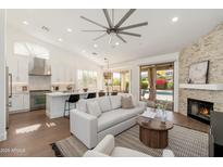 Open-concept living room with fireplace, and sliding doors to the pool area at 6428 E Nisbet Rd, Scottsdale, AZ 85254