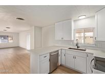 Updated kitchen features new white cabinets and countertops and stainless steel appliances at 714 S 86Th Pl, Mesa, AZ 85208