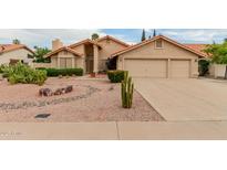Single-story home featuring a three-car garage, low maintenance desert landscaping, and a red tile roof at 1139 E Stephens Dr, Tempe, AZ 85283