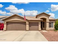 Charming single-story home features a three-car garage and manicured landscaping at 1144 W Tremaine Ave, Gilbert, AZ 85233