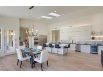 Bright, open kitchen with a marble island, stainless appliances, and a dining area at 12225 E Cortez Dr, Scottsdale, AZ 85259