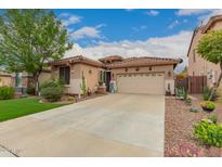 Charming home featuring a low-maintenance desert landscape and beautiful turf lawn at 17797 W Statler Dr, Surprise, AZ 85388