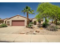 Charming single-story home featuring desert landscaping, a two-car garage, and a welcoming facade at 20007 N Organ Pipe Dr, Surprise, AZ 85374