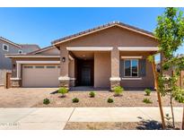 Charming single-story home featuring a well-maintained front yard, covered porch, and neutral color palette at 21838 E Bonanza Ct, Queen Creek, AZ 85142