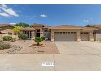 Charming single-story home with a three-car garage and well-maintained desert landscaping at 6528 W Via Montoya Dr, Glendale, AZ 85310