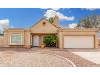 Charming single-story home with a neutral stucco exterior, manicured landscaping and attached garage at 7229 S Butte Ave, Tempe, AZ 85283