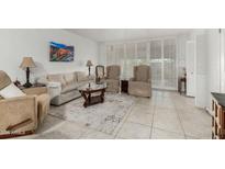Bright living room with tile floors, neutral furniture, and stylish coffee table at 7625 E Camelback Rd # B124, Scottsdale, AZ 85251