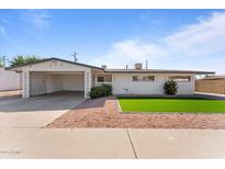 Charming single-story home featuring a carport, low maintenance landscaping, and a bright white exterior at 8044 N 10Th Pl, Phoenix, AZ 85020