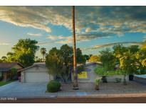 Charming single-story home featuring a two-car garage and mature trees in a well-maintained front yard at 8338 E Monterosa St, Scottsdale, AZ 85251