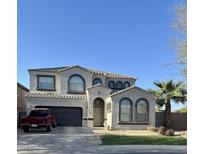 Charming two-story home features a well-manicured lawn, desert landscaping, and a private driveway at 9108 W Kirby Ave, Tolleson, AZ 85353