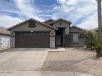 Charming single-story home with a well-maintained gravel front yard and a two-car garage at 3229 W Five Mile Peak Dr, San Tan Valley, AZ 85144