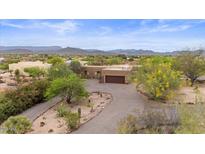 Aerial view of home showcasing desert landscaping, a spacious driveway, and a mountain backdrop at 36223 N 17Th Ave, Phoenix, AZ 85086