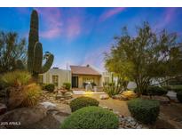 Southwestern-style home featuring a front yard with mature landscaping and a charming water fountain at 5001 E Redfield Rd, Scottsdale, AZ 85254