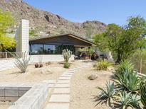 Charming home with desert landscaping, stone pathway, and mountain views at 5412 E Rockridge Rd, Phoenix, AZ 85018