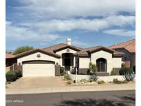 Charming stucco home featuring tile roofing, desert landscaping, and attached two-car garage at 14253 N Honeysuckle N Dr, Fountain Hills, AZ 85268