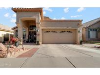 Charming single-Gathering home with a welcoming front entrance and a well-maintained driveway and desert landscaping at 1437 E Glenhaven Dr, Phoenix, AZ 85048