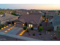 Exterior elevation of a well-maintained home with a desert-landscaped yard at dusk at 3713 W Abrams Dr, New River, AZ 85087
