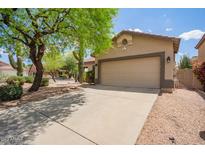 Charming single-story home features a desert landscape and a two-car garage at 4119 E Tether Trl, Phoenix, AZ 85050