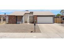 Charming single-story home featuring a brick facade, two-car garage, and well-maintained front yard at 4631 N 77Th Dr, Phoenix, AZ 85033