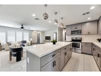Contemporary kitchen with stainless steel appliances, a center island, and stylish pendant lighting at 6805 N 12Th St, Phoenix, AZ 85014