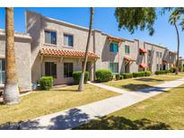 Charming townhome featuring stucco exterior, red tile accents, and well-maintained landscaping at 8107 E Vista Dr, Scottsdale, AZ 85250