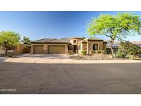 Charming home featuring a tile roof, a three-car garage and low-maintenance desert landscaping at 9628 E Inglewood Cir, Mesa, AZ 85207