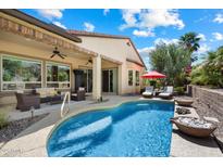 Beautiful backyard pool with seating area and an outdoor kitchen, perfect for entertaining at 12962 W Lone Tree Trl, Peoria, AZ 85383