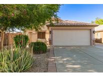 Charming single-story home with a two-car garage and well-manicured landscaping at 15814 W Adams St, Goodyear, AZ 85338
