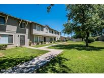 Charming townhomes with well-maintained lawns and mature trees, offering a serene community atmosphere at 2645 W Elm St, Phoenix, AZ 85017