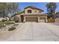Charming two-story home featuring a three-car garage and desert landscaping at 6264 E Omega St, Mesa, AZ 85215