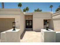 Inviting front entrance features double doors, warm lighting, and a charming brick pathway at 8425 E Welsh Trl, Scottsdale, AZ 85258