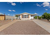 Charming home featuring a covered carport and low-maintenance front yard at 1053 S 96Th St, Mesa, AZ 85208