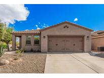 Charming single-story home with desert landscaping and a two-car garage at 12335 W Rosewood Ln, Peoria, AZ 85383