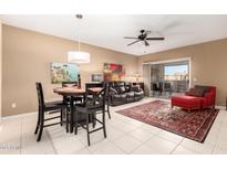 Inviting living room with a sliding glass door, modern ceiling fan, and a dining table set at 16626 E Westby Dr # 108, Fountain Hills, AZ 85268