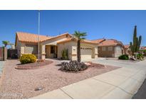 Charming single-story home featuring desert landscaping and a tile roof at 17640 W Babbitt Dr, Surprise, AZ 85374