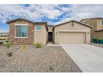 Charming single-Gathering home with stone accents, a two-car garage, and desert landscaping at 18766 W Montebello Ave, Litchfield Park, AZ 85340