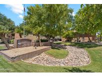 The Chesapeake Condominiums entrance features beautiful landscaping, rock features, and mature trees at 200 E Southern Ave # 133, Tempe, AZ 85282