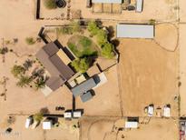 Aerial view of a horse property with expansive land, multiple structures, and well-maintained horse facilities at 28061 N Holly Rd, San Tan Valley, AZ 85143