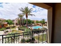 View of the community pool with palm trees and lounge chairs, seen from a balcony at 4777 S Fulton Ranch Blvd # 1024, Chandler, AZ 85248